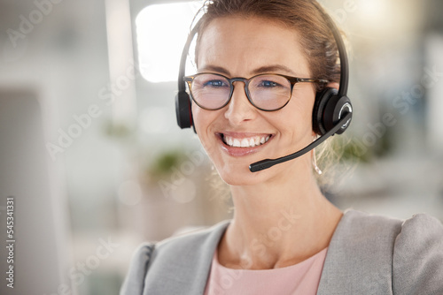 Business woman in call center, happy customer service support agent in office or working online in Berlin. Professional telemarketing consultant, help desk job or contact us for crm communication photo