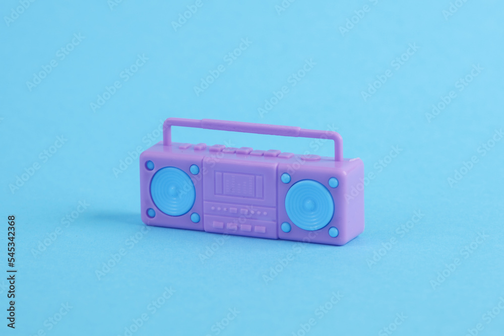 Fototapeta premium Plastic miniature boombox audio player on a blue background