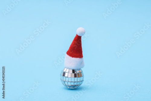 Disco ball in santa hat, blue background
