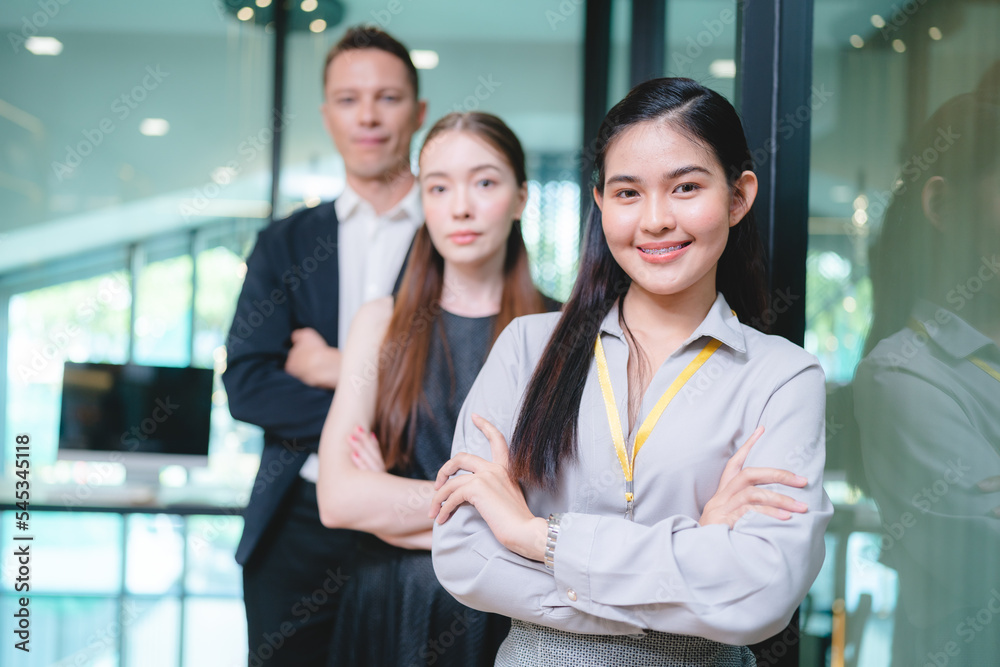 Fototapeta premium Young Asian business man in formal clothing showing something on digital tablet to senior female boss and manager wearing eyeglasses while in a meeting and training on technology
