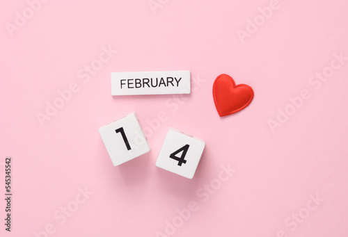 February 14 wooden calendar with heart on pink background. Valentine's Day