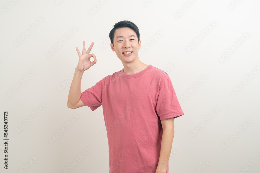 young Asian man thumbs up or ok hand sign