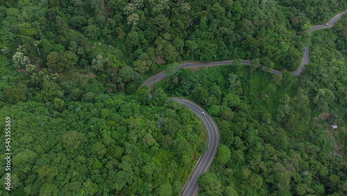 Road through green forest, aerial view road passing through forest in Aceh province, Indonesia © Azmil