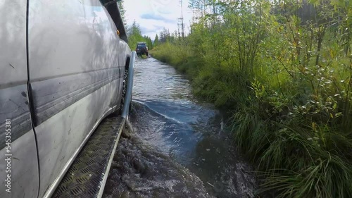 The car overcomes a difficult road. Swamps, rivers, mud, forest road