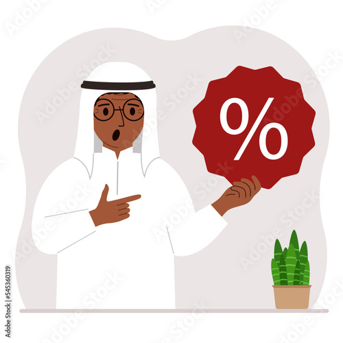A man holds a percent sign in his hand. The concept of percentage, discount, promotion, interest rate, percent discount in shopping.