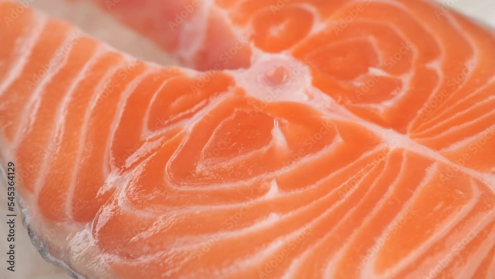 Raw, fresh salmon steak on ice cubes, slider shot. Buy fish in the market or in the store