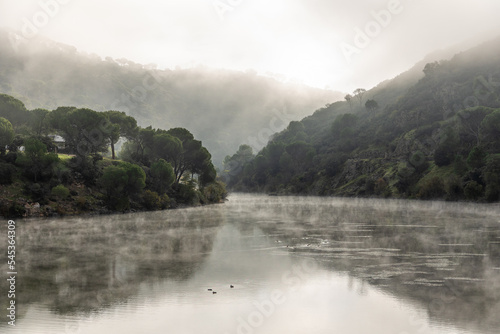 water of the Picadas reservoir in Madrid covered by fog at dawn