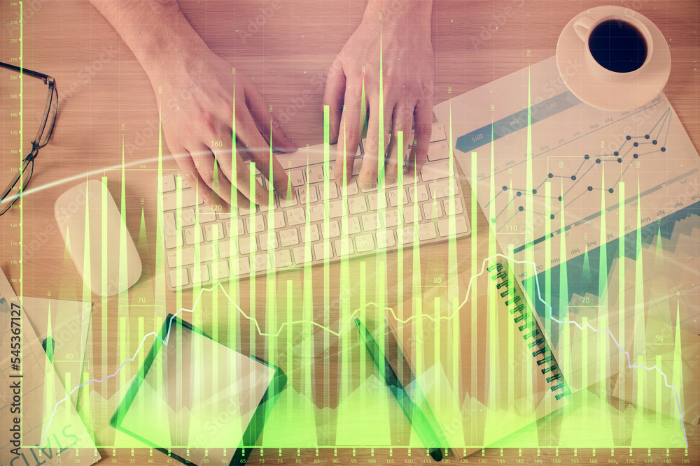 Multi exposure of man's hands typing over computer keyboard and forex graph hologram drawing. Top view. Financial markets concept. Multi exposure of man's hands typing over computer keyboard and forex graph hologram drawing. Top view. Financial markets concept.