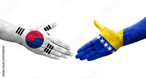 Handshake between South Korea and Bosnia flags painted on hands  isolated transparent image.