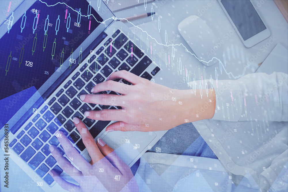 Double exposure of woman hands working on computer and forex chart hologram drawing. Top View. Financial analysis concept. Double exposure of woman hands working on computer and forex chart hologram drawing. Top View. Financial analysis concept.