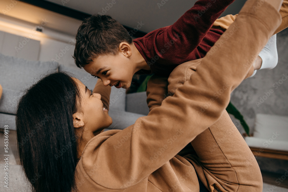 Mom teaches her son to do sports physical exercises in the morning at home Mom teaches her son to do sports physical exercises in the morning at home