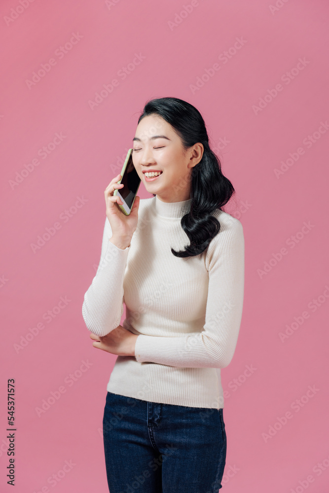 Beautiful young asian woman who talks on the telephone Beautiful young asian woman who talks on the telephone