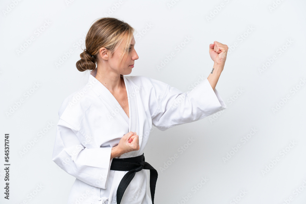 Young caucasian woman isolated on white background doing karate Young caucasian woman isolated on white background doing karate