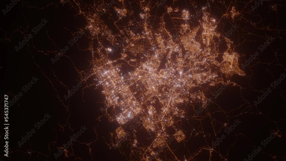 Islamalabad (Pakistan) aerial view at night. Top view on modern city with street lights. Camera is zooming out, rotating counterclockwise. Vertical video. The north is on the left side