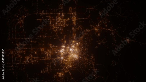 Helena (Montana, USA) top view at night. Aerial view on modern city from space. Camera is flying above the city, moving forward. Vertical video. The north is on the left side photo