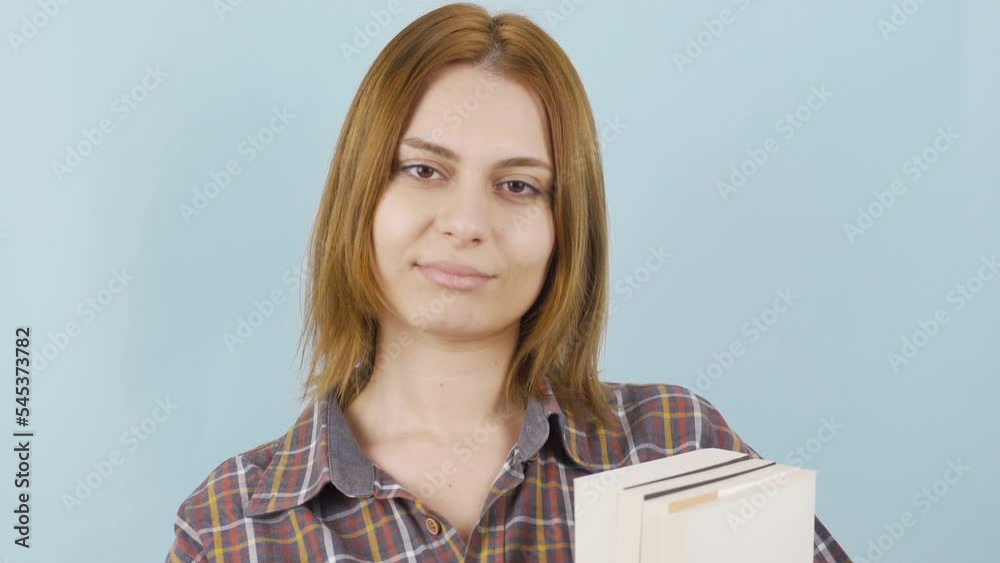 Close-up of young female student holding a book.
Young girl holds books in her hands and looks at the camera.
Close-up of young female student holding a book.
Young girl holds books in her hands and looks at the camera.