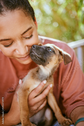 Love  care and pet dog with black woman in garden for bond  affection and happiness together. Wellness  calm and healthy adoption puppy bonding embrace with happy girl owner in backyard.