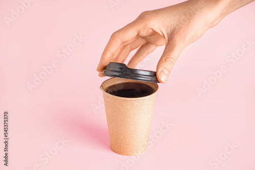 Woman closing cup of coffee...