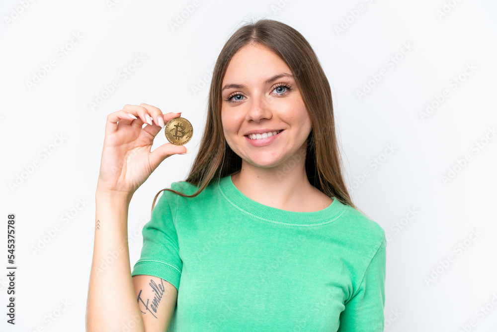 Young beautiful blonde woman holding a Bitcoin isolated on white background smiling a lot Young beautiful blonde woman holding a Bitcoin isolated on white background smiling a lot