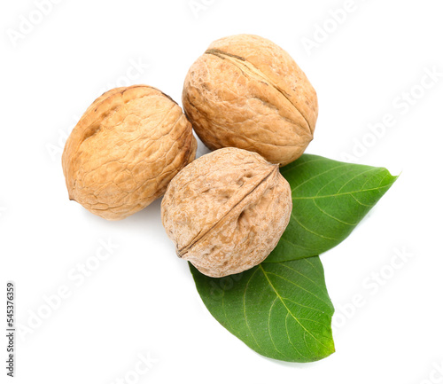 Whole fresh walnuts on white background