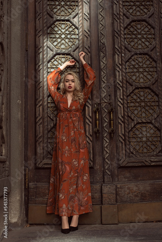 Young blonde woman in autumn city