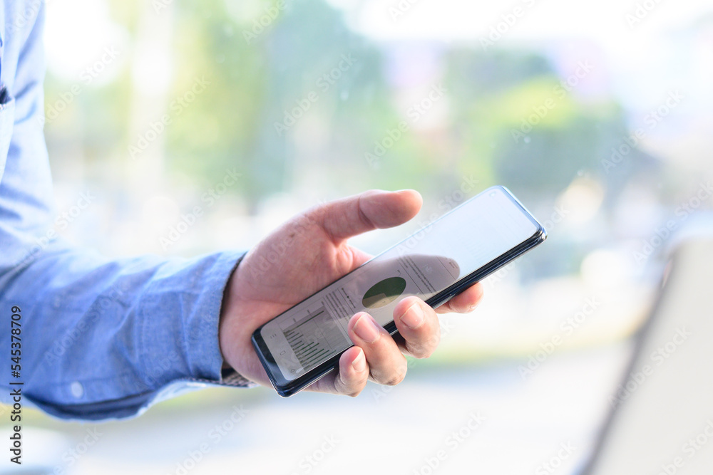Businessman checking smartphone and laptop Businessman checking smartphone and laptop