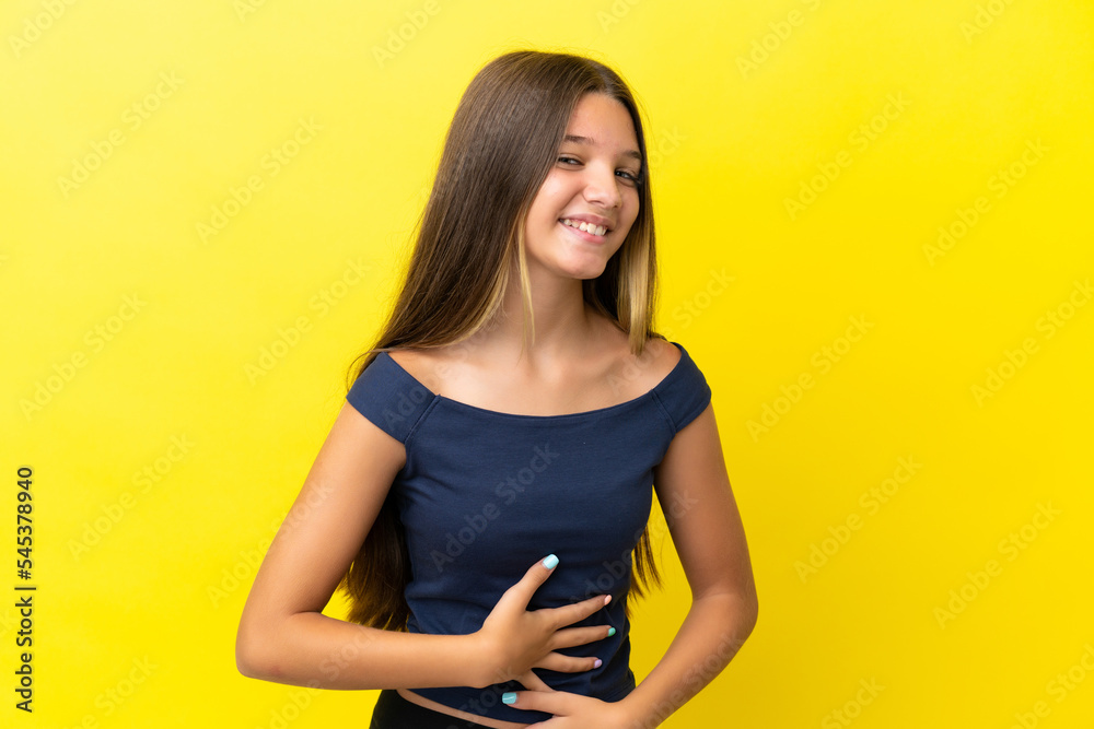 Little caucasian girl isolated on yellow background smiling a lot Little caucasian girl isolated on yellow background smiling a lot