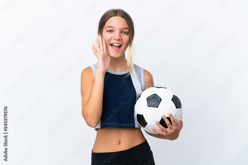 Little caucasian girl playing football isolated on white background shouting with mouth wide open