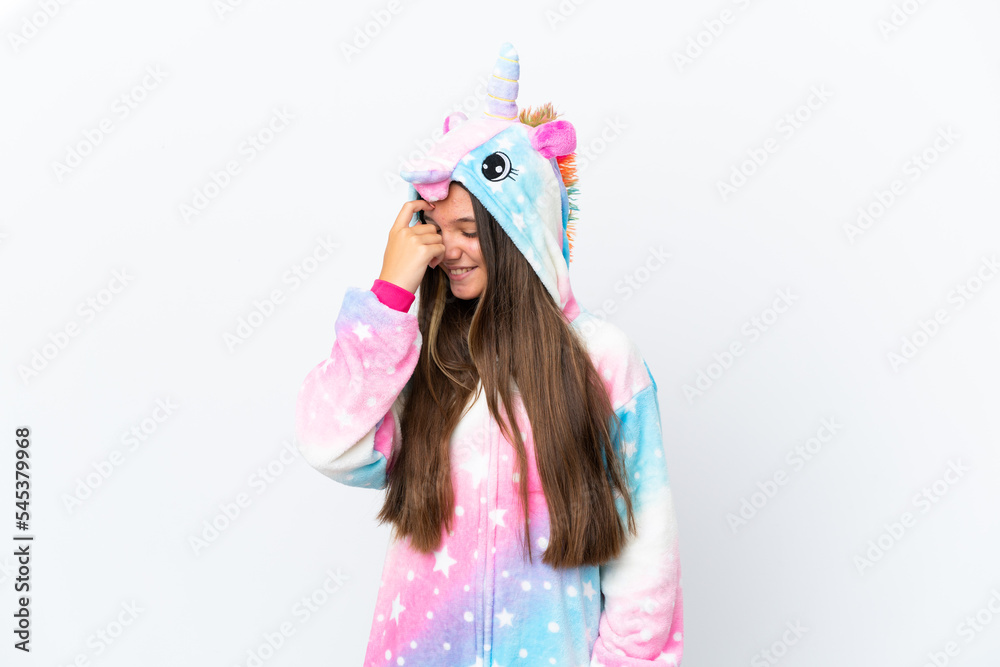 Little caucasian girl wearing unicorn pajama isolated on white background laughing Little caucasian girl wearing unicorn pajama isolated on white background laughing