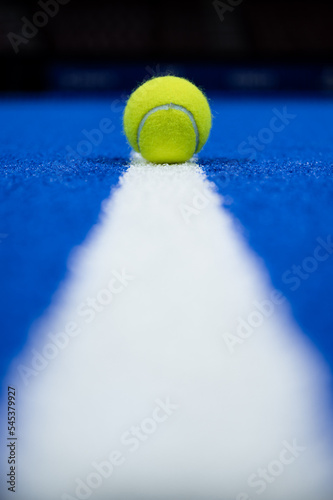 Padel ball on the line of the court