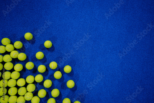 Obraz na plátně Combination of padel balls on the court in the left corner