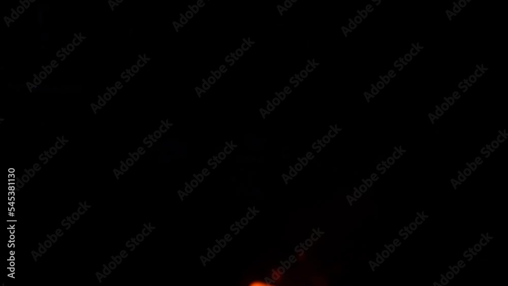 Campfire in the forest. Beautiful landscape of nature and trees. Sparks and flames. Rest by the fire. Camping in the woods. Burning firewood. Night bonfire. Fire on a black background. VFX effect
