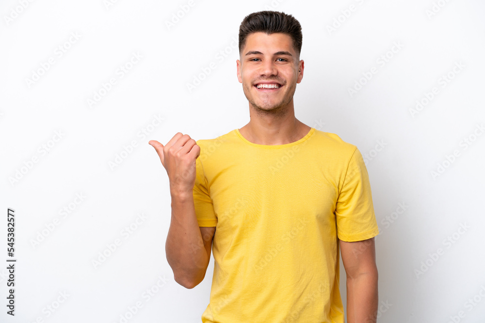 Young caucasian man isolated on white background pointing to the side to present a product Young caucasian man isolated on white background pointing to the side to present a product