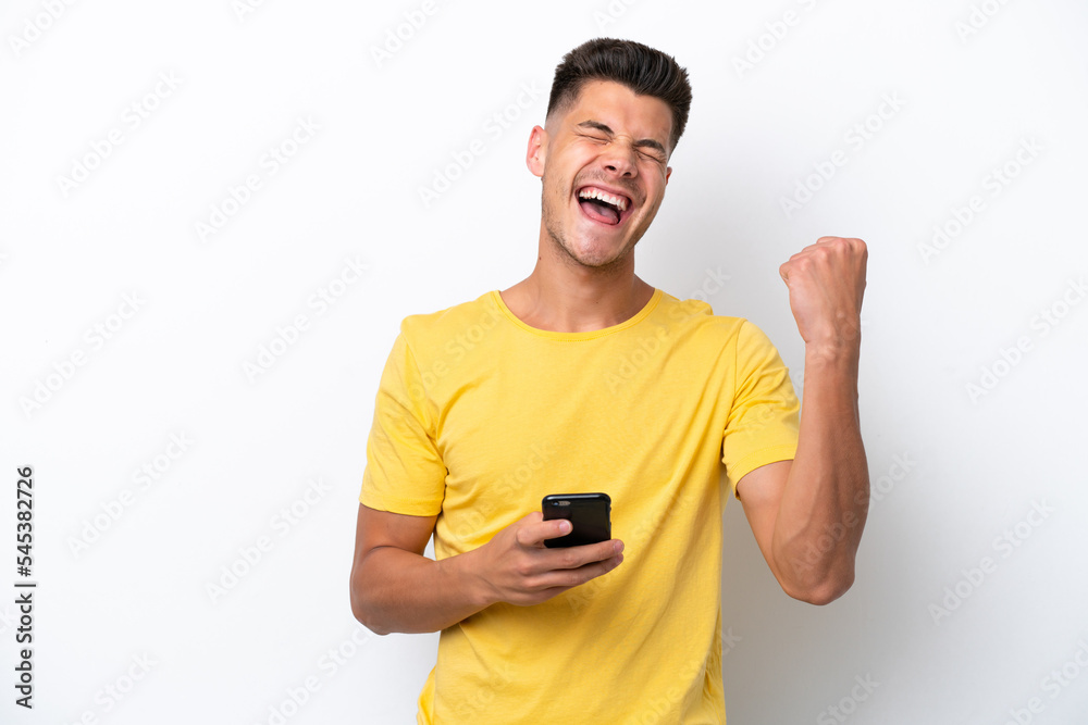 Young caucasian man isolated on white background with phone in victory position Young caucasian man isolated on white background with phone in victory position