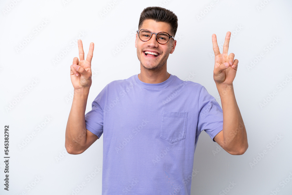 Young caucasian man isolated on white background showing victory sign with both hands Young caucasian man isolated on white background showing victory sign with both hands