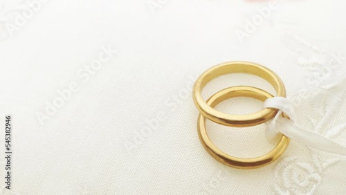 Wedding rings on ring pillow slow zoom