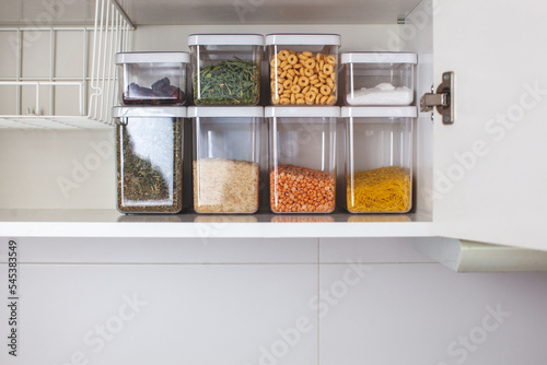 Storage ideas in the kitchen. White box and basket. Shelf order system. Modern interior.  photo