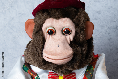 Retro toy monkey jolly chimp on gray background 