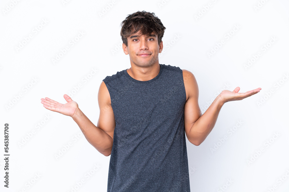 Young sport caucasian man isolated on white background having doubts while raising hands Young sport caucasian man isolated on white background having doubts while raising hands