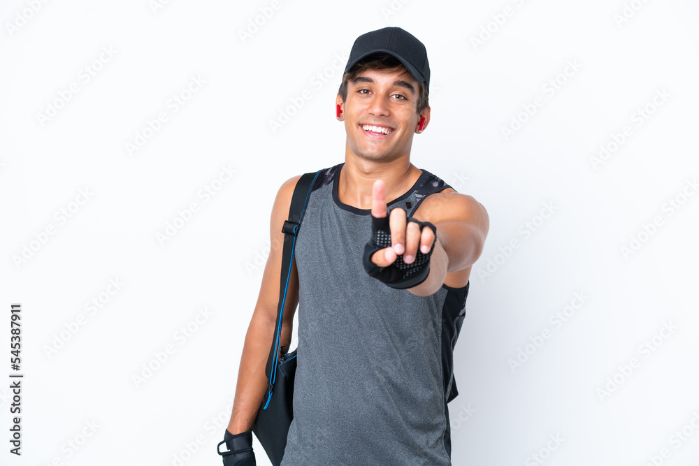 Young sport caucasian man with sport bag isolated on white background showing and lifting a finger Young sport caucasian man with sport bag isolated on white background showing and lifting a finger
