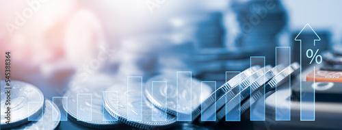 Economy, finance and investment background. Coins and calculator with financial graph growth of inflation and interest rate hike. economy development report, business improvement