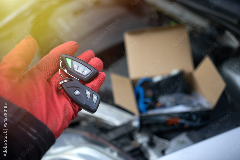 The alarm control panel is in the hands of the master. Installation of a car alarm system in the service center.The access key for the car.