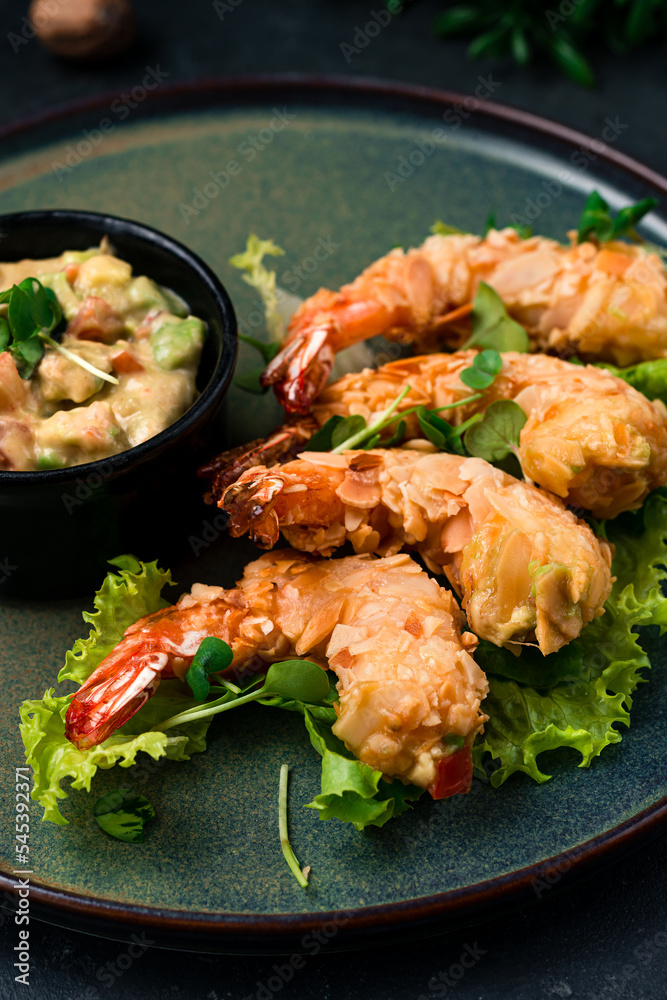 Asian traditional food fried shrimp in almond flakes with lettuce and vegetable dressing. Asian traditional food fried shrimp in almond flakes with lettuce and vegetable dressing.