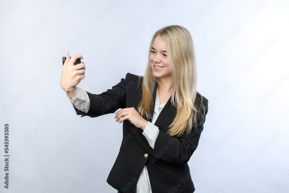 Young beautiful blonde woman making selfie by retro camera on white background Young beautiful blonde woman making selfie by retro camera on white background