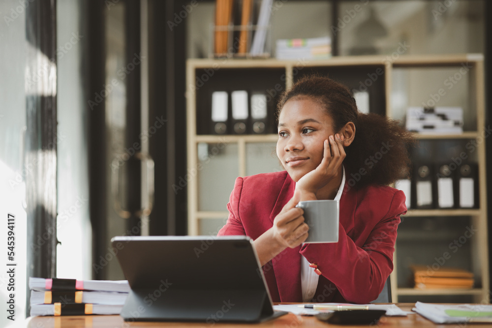 American woman sits in the office of a startup company, she is a company employee, young generation operations run the company with the concept of the new generation. Company management concept