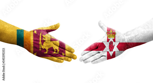 Handshake between Sri Lanka and Northern Ireland flags painted on hands, isolated transparent image. photo