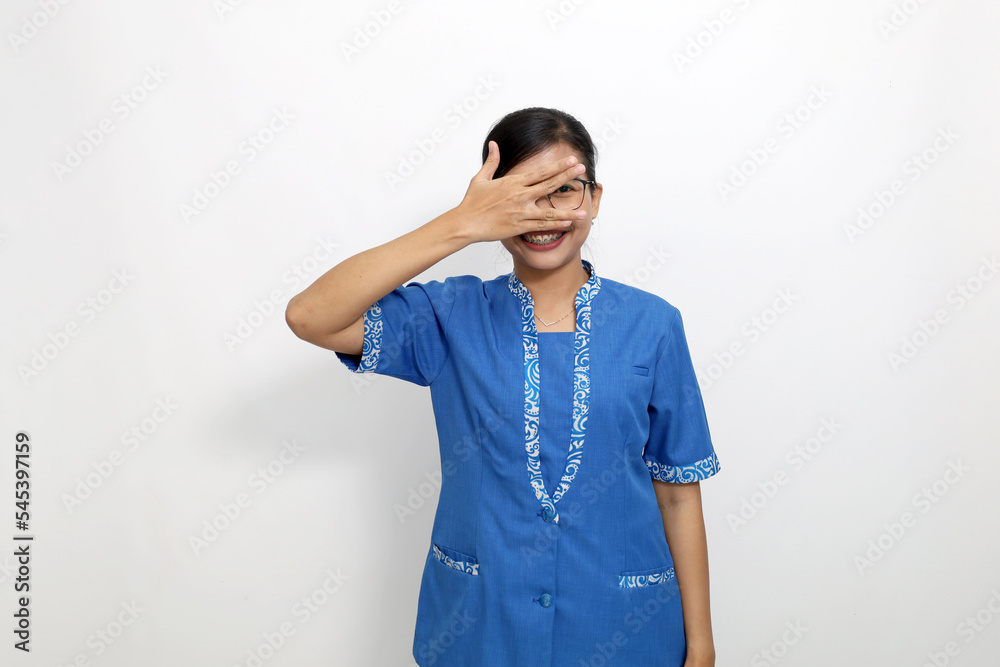 Funny young asian woman standing while laughing and covering her face. Isolated on white background Funny young asian woman standing while laughing and covering her face. Isolated on white background