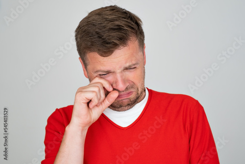 upset crying man in red shirt gesturing with his hands