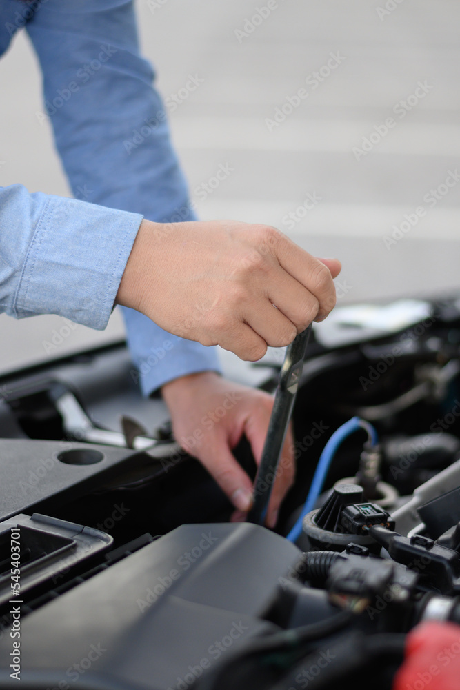 man holding car repair equipment man holding car repair equipment