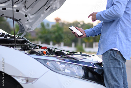 Man calling to check engine on smartphone
